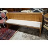 A Victorian style pitch pine pew with cushion seat, length 187cm, depth 40cm, height 88cm