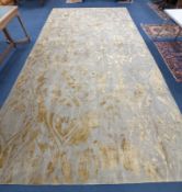 A contemporary 'Son' Nepalese wool and silk stone grey and gold carpet, 490 x 270cm
