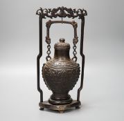 A Chinese archaistic bronze hanging vessel, wood stand 34cm