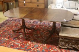 A William Tillman style reproduction mahogany twin pillar extending dining table, 186cm extended, (