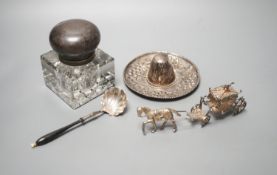 A silver mounted glass inkwell, A Mexican white metal miniature sombrero, a white metal caddy