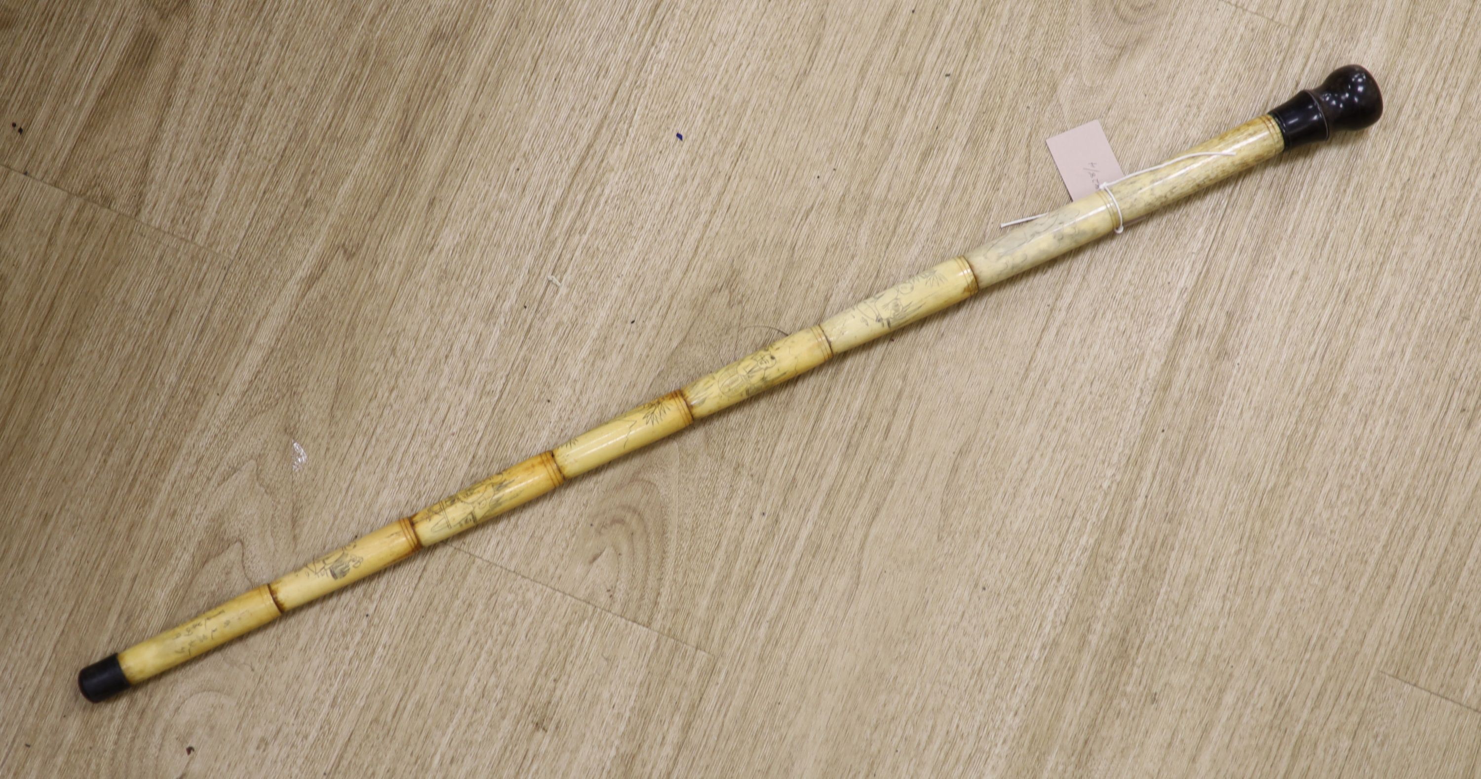 An engraved bone walking cane, 84cm