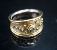 A modern two colour 18ct gold and three stone diamond set dress ring by Elisabeth Gage, size K/L,