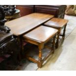 A nest of three Ercol elm tables, largest width 114cm, depth 49cm, height 41cm