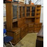 An Ercol elm four section modular wall unit, width 244cm, depth 49cm, height 197cm