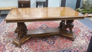 An Italian design rectangular walnut centre table with winged sphinx supports, width 196cm, depth