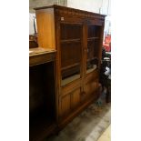 An Ercol elm bookcase, length 101cm, depth 30cm, height 137cm