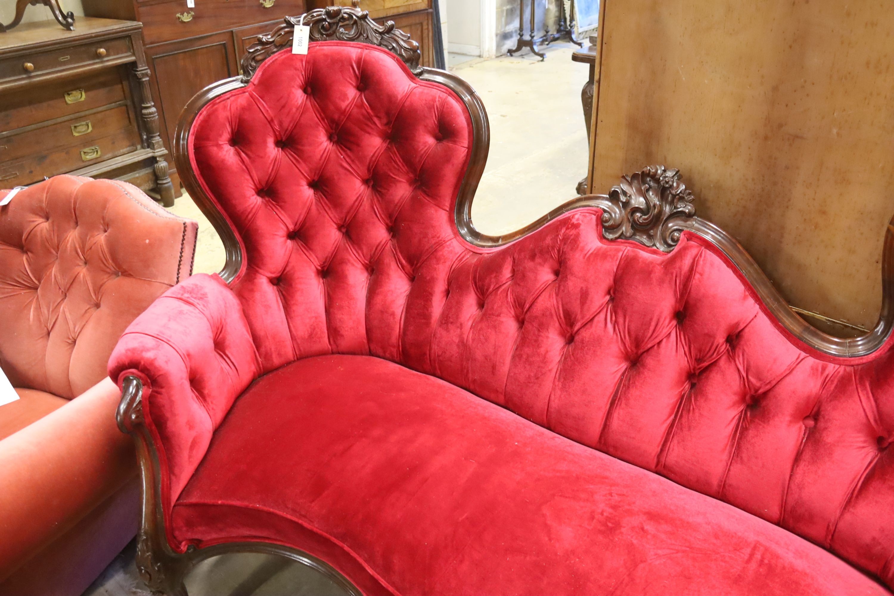 A Victorian carved rosewood double spoon back settee upholstered in deep buttoned scarlet velvet, - Image 3 of 5