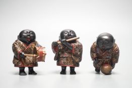 A set of three Japanese lacquered composition ‘musician’ netsuke, 6.5cm