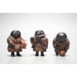 A set of three Japanese lacquered composition ‘musician’ netsuke, 6.5cm