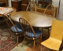 An Ercol elm oval extending dining table, 148cm extended, width 97cm, height 74cm, together with a