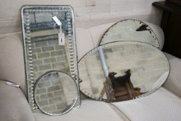 An oblong mirror, circular mirror, oval mirror and a mirrored table plateau, all frameless,