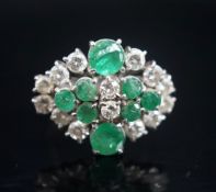 A 20th century 18ct white metal, emerald and diamond set cluster dress ring, size O/P, gross