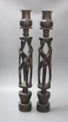 A pair of African tribal figural ebony candlestands, 60cm