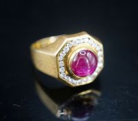 A modern continental yellow metal, cabochon ruby and diamond cluster set octagonal dress ring,
