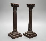 A pair of early 20th century cast iron Corinthian column candlesticks 30cm