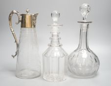 Two cut glass decanters and a claret jug 30cm