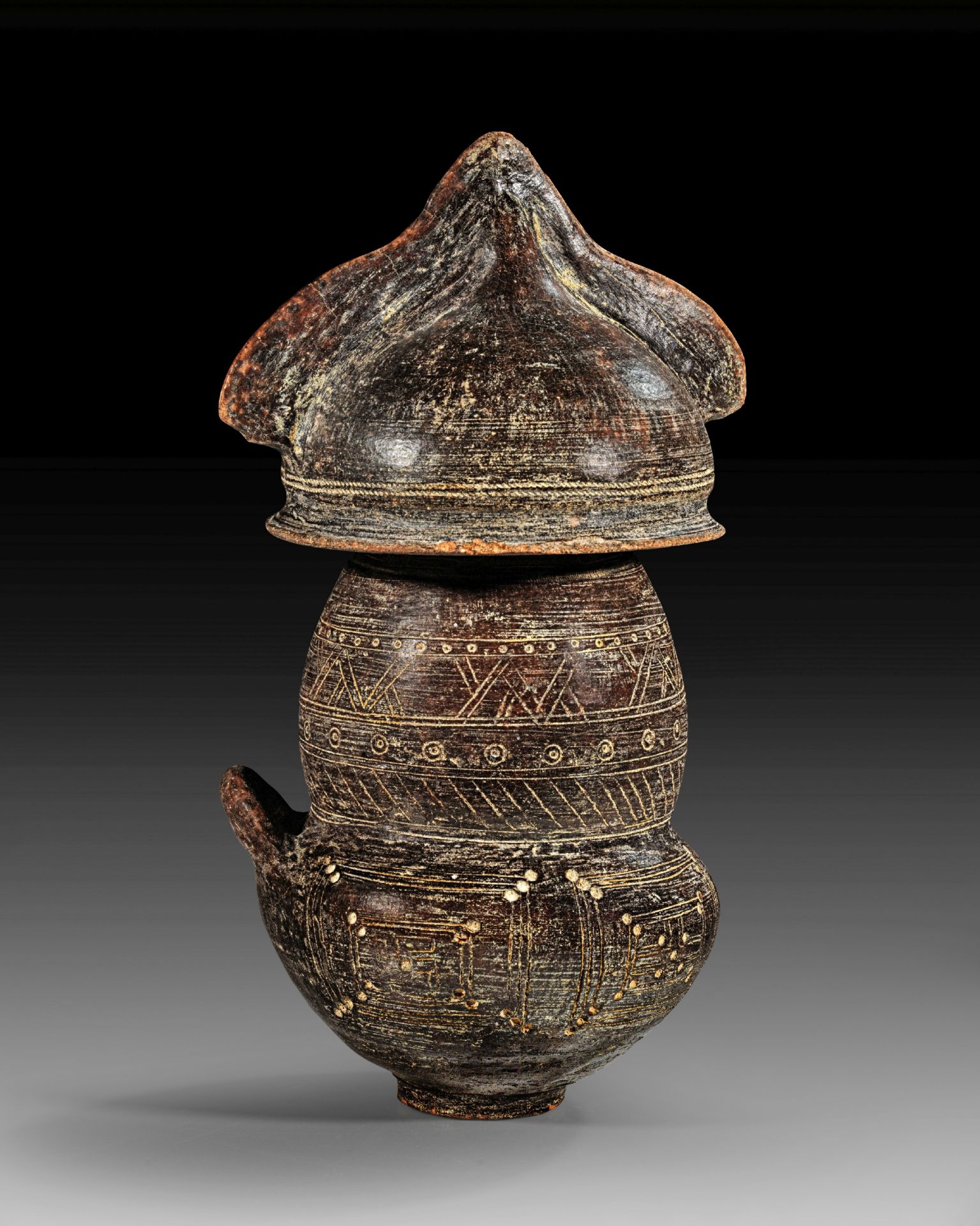 Villanova biconical urn with lid in form of a crested helmet.