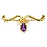 AN AMETHYST SET 9CT GOLD BAR BROOCH the double scroll design with pear cut amethyst drop, 4cm