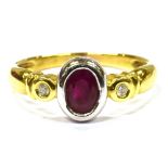 A RUBY AND DIAMOND THREE STONE 18CT GOLD RING the oval cut ruby approx. 7 x 5mm, with two small
