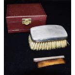 A GENTLEMAN BOXED GARRARD SILVER BRUSH AND COMB With engine turned finish, the brush 11cms x 6cms