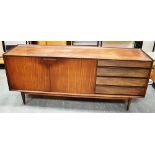 A TEAK SIDEBOARD with pair of doors opening to shelved interior, flanked by four drawers, on
