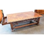 AN OAK COFFEE TABLE the rectangular top with carved border, carved frieze with drawer to each end,