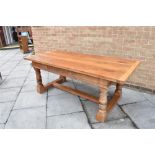 A RUSTIC OAK REFECTORY DINING TABLE the three plank top with cleated ends, 88cm x 200cm, the