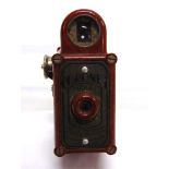 A CORONET MIDGET CAMERA in mottled red bakelite, the case in good condition (mechanism not tested).