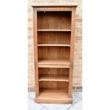 AN ERCOL 'GOLDEN DAWN' OPEN BOOKCASE fitted with one fixed and three adjustable shelves, 64cm wide