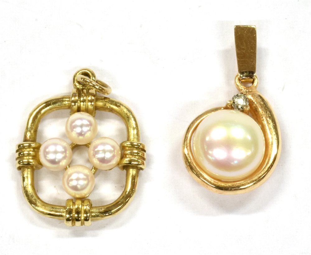 TWO SMALL CULTURED PEARL SET GOLD PENDANTS comprising a single button shaped pearl set with very