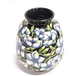 A MOORCROFT POTTERY VASE WITH TUBELINED FLORAL DECORATION on a dark blue ground, dated '98 and