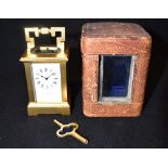 A MINATURE GILT METAL FRAMED CARRIAGE CLOCK the enamel dial with Roman numerals signed 'J. Ritchie &