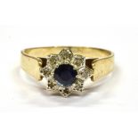 A 9CT GOLD SMALL SAPPHIRE AND DIAMOND CLUSTER RING the central round sapphire with small illusion
