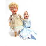 TWO DOLLS comprising a bisque socket-head doll, with a cropped curly blonde wig, sleeping grey glass