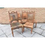 A GROUP OF FIVE MATCHING VICTORIAN CARVED OAK FRAMED DINING CHAIRS with leather upholstered seats