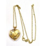 A 9CT GOLD HEART LOCKET AND CHAIN The locket 2cms long, to a fine link chain 18 inches long, gross