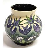 A MOORCROFT POTTERY VASE DECORATED IN THE 'HERALDS OF SPRING PATTERN, with tubelined decoration of