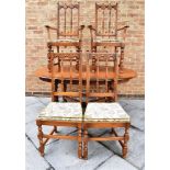 AN ERCOL 'GOLDEN DAWN' EXTENDING DINING TABLE and set of four chairs including pair of carvers