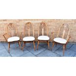 A PAIR OF ERCOL SWAN BACK CARVED CHAIRS and a matching pair of dining chairs