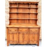 AN ERCOL 'OLD COLONIAL' RANGE DRESSER in 'Golden Dawn' colour, three tier waterfall plate rack above