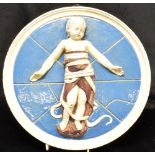 AN ITALIAN CANTAGALLI CIRCULAR MAIOLICA PLAQUE relief decorated with an infant in swaddling, 31cm