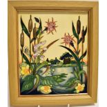 A MOORCROFT POTTERY PLAQUE DECORATED IN THE 'RUNNYMEADE' PATTERN in light oak frame, signed by
