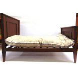 A SMALL INFANT'S OR DOLL'S OAK BED together with a mattress and bedding, 55cm high (headboard), 82cm