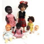 SEVEN HARD PLASTIC DOLLS including two with walking mechanisms, the largest 58cm high (one doll