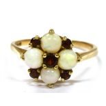 AN OPAL AND GARNET CLUSTER 9CT GOLD DRESS RING the cluster comprising four round white opals and