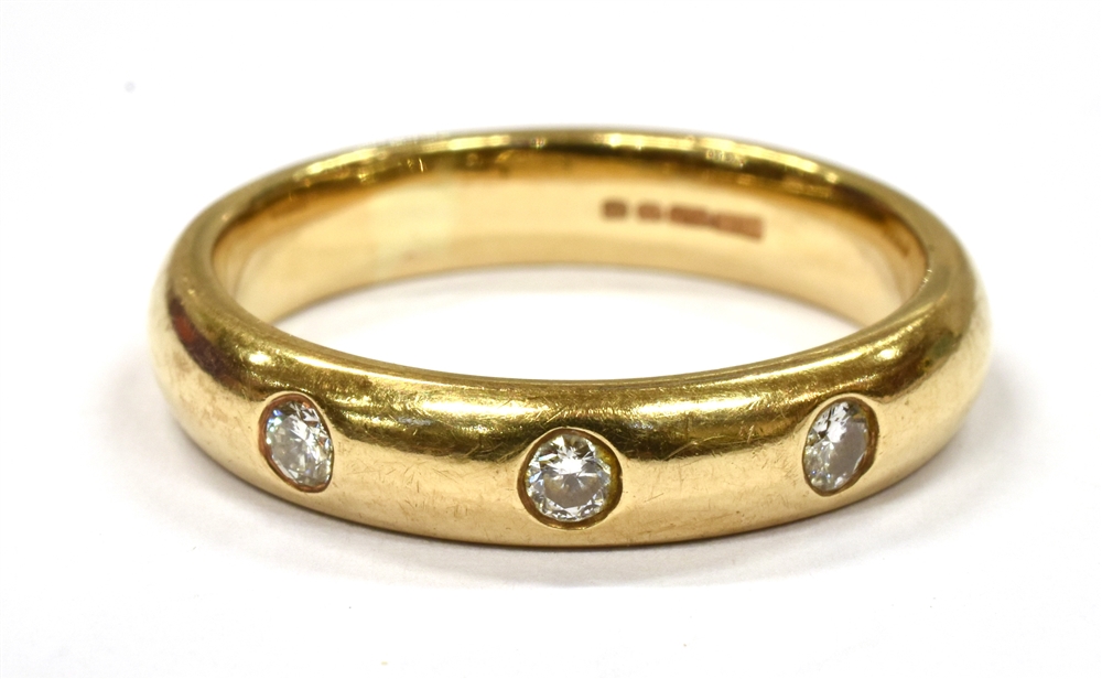 A DIAMOND SET 9CT GOLD WEDDING BAND the plain yellow gold band flush set with three small round