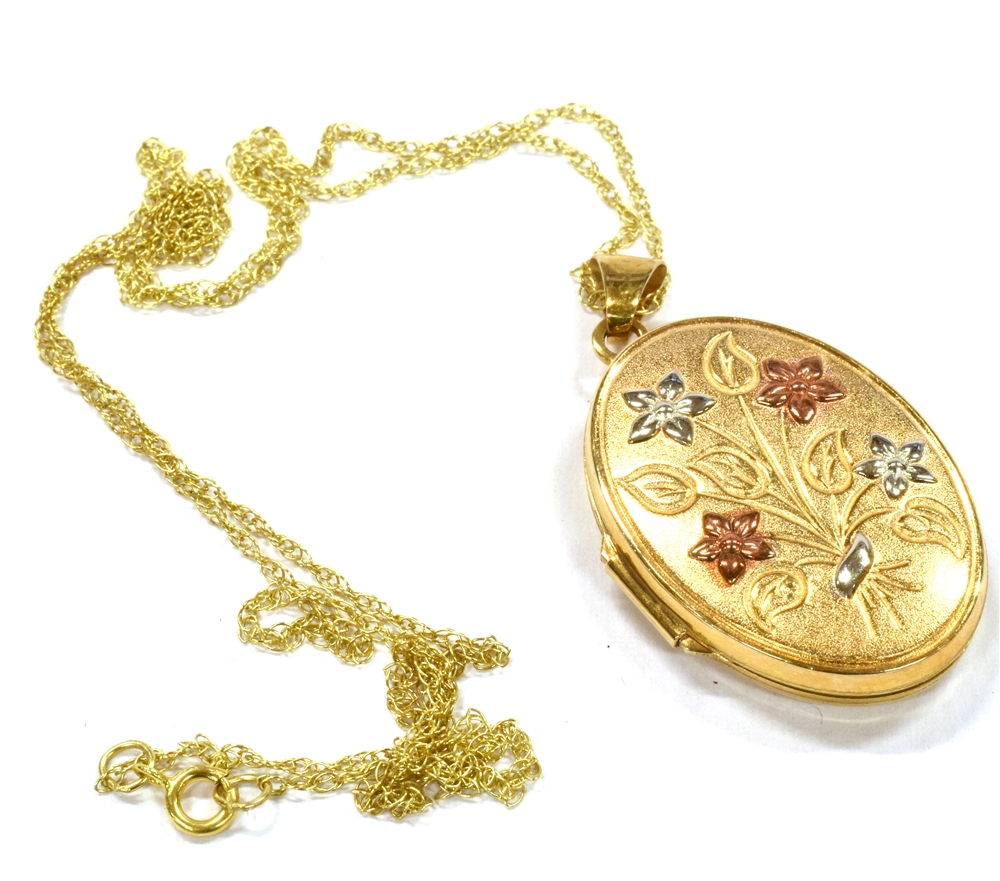 A MODERN 9CT GOLD OVAL LOCKET AND CHAIN the embossed flower spray to the front with red and white