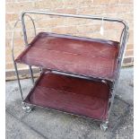 A BREMSHEY & CO 'DINETT' FOLDING TWO TIER TROLLEY with chrome plated steel frame, and folding wood-