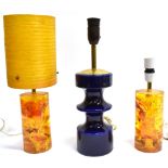 TWO AMBER COLOURED SHATTERLINE TABLE LAMPS one with cylindrical spun fibreglass shade, and a Steuler